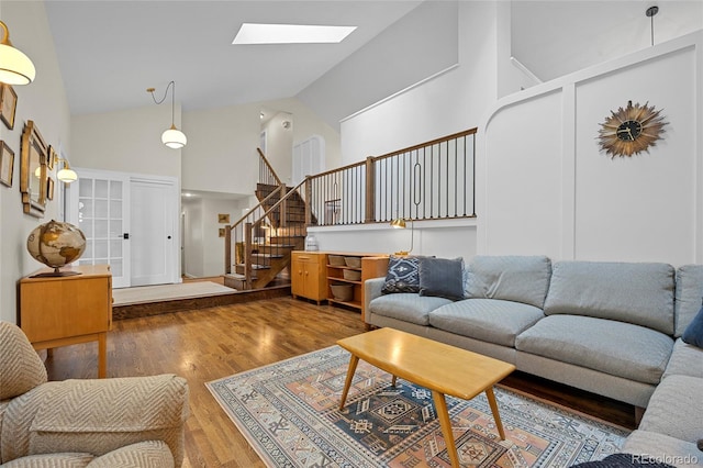 11035 E Berry Ave, Englewood, CO 80111 - living area featuring high vaulted ceiling, a skylight, wood finished floors, and stairs