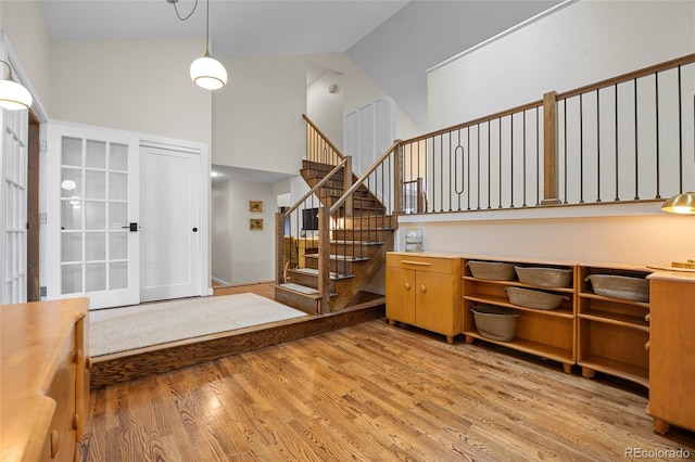 11035 E Berry Ave, Englewood, CO 80111 - entrance foyer with light wood-type flooring, stairs, and a high ceiling