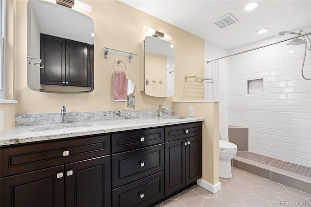 11035 E Berry Ave, Englewood, CO 80111 - full bath with double vanity, tiled shower, tile patterned flooring, and recessed lighting