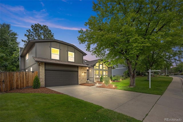 11035 E Berry Ave, Englewood, CO 80111 - view of front facade with a garage, driveway, and brick siding