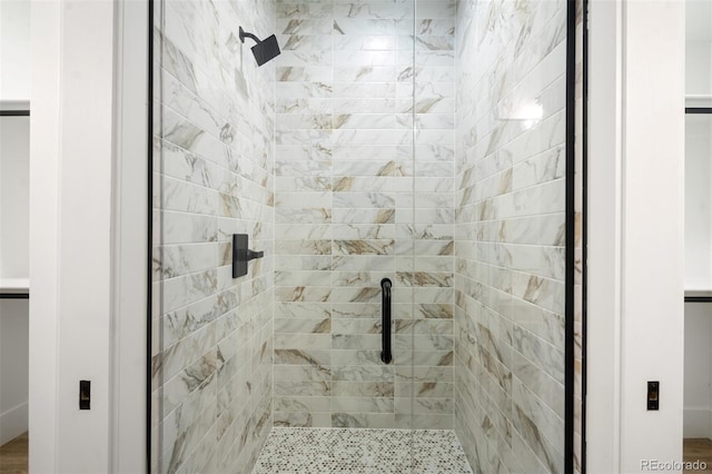 bathroom with a shower with door