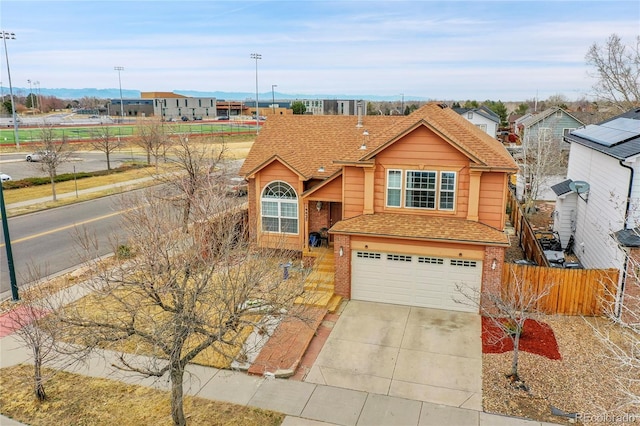 14425 E 50th Ave, Denver, CO 80239 - view of front of home with brick siding, an attached garage, driveway, and a shingled roof