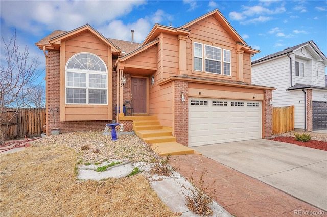 14425 E 50th Ave, Denver, CO 80239 - view of front of home featuring brick siding, an attached garage, and concrete driveway