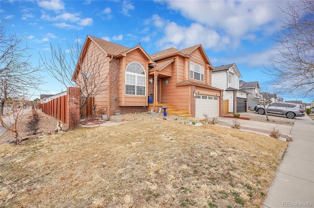 14425 E 50th Ave, Denver, CO 80239 - view of front of house featuring brick siding, driveway, and an attached garage