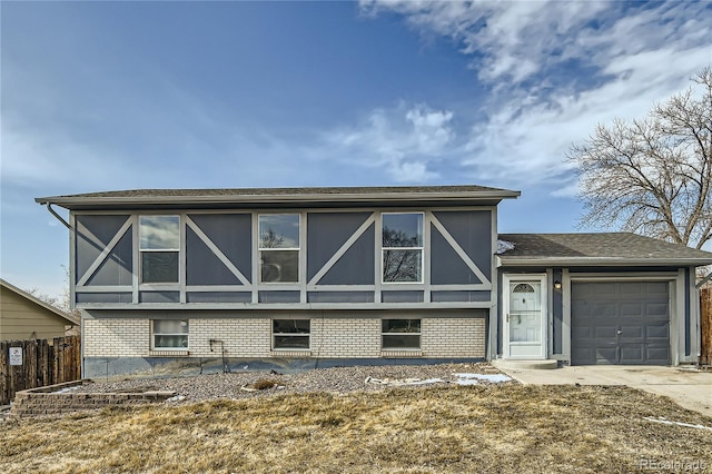 view of front of home featuring driveway, brick siding, an attached garage, and stucco siding