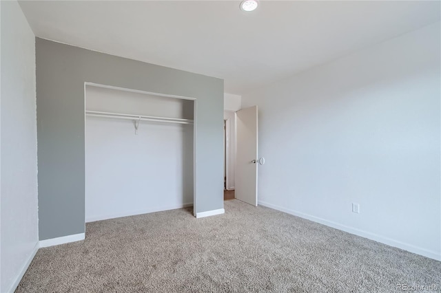 unfurnished bedroom featuring a closet, carpet flooring, and baseboards