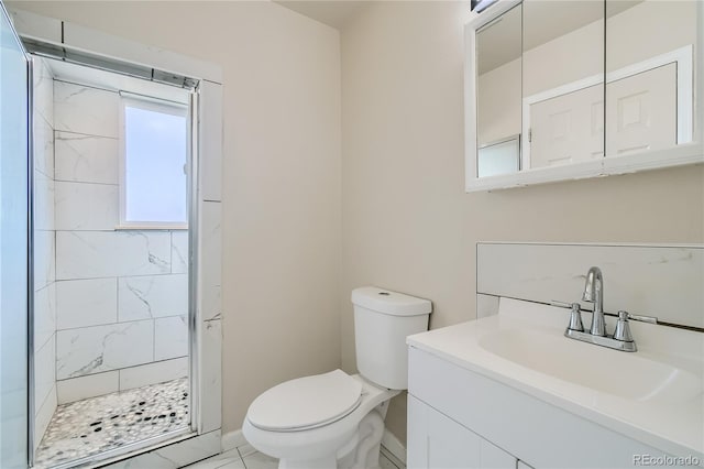 bathroom featuring a shower stall, vanity, and toilet