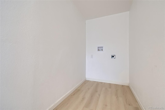 clothes washing area with laundry area, baseboards, hookup for a washing machine, light wood-type flooring, and electric dryer hookup