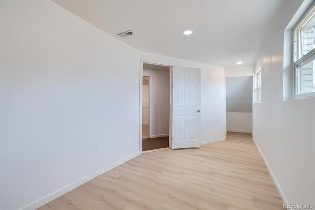 spare room with baseboards, recessed lighting, visible vents, and light wood-style floors