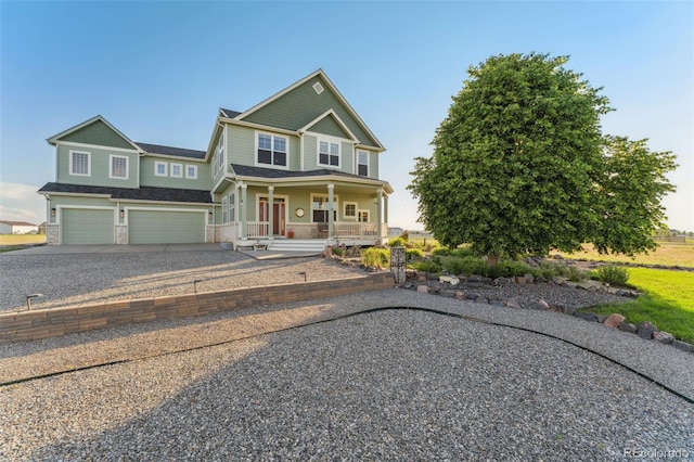 881 Kirby Ct, Watkins, CO 80137 - craftsman-style home featuring covered porch, an attached garage, driveway, and stone siding