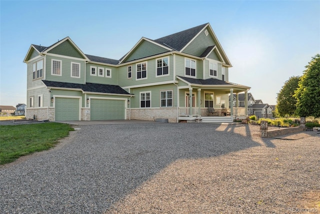 881 Kirby Ct, Watkins, CO 80137 - craftsman house with covered porch, an attached garage, driveway, and stone siding