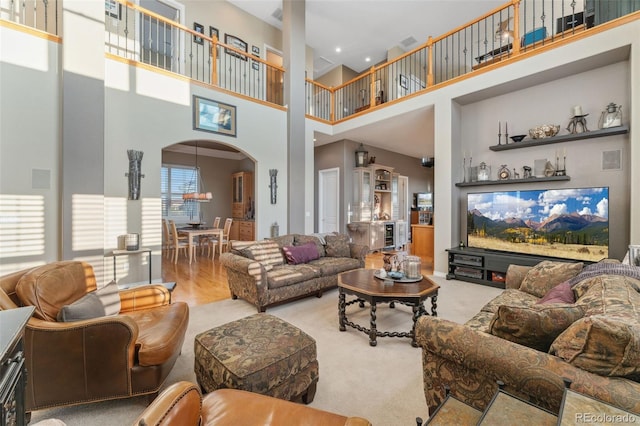 881 Kirby Ct, Watkins, CO 80137 - living room featuring arched walkways and a high ceiling