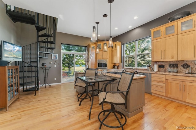 881 Kirby Ct, Watkins, CO 80137 - kitchen featuring appliances with stainless steel finishes, light wood finished floors, light brown cabinetry, and recessed lighting