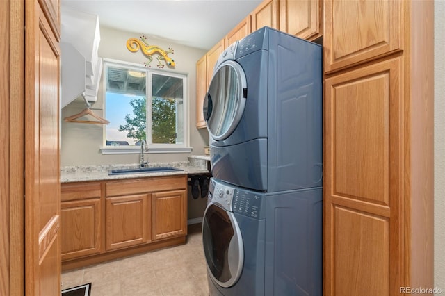 881 Kirby Ct, Watkins, CO 80137 - laundry area with stacked washing machine and dryer, cabinet space, and light tile patterned flooring