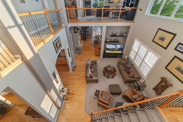 881 Kirby Ct, Watkins, CO 80137 - living area featuring a high ceiling, wood finished floors, and stairs