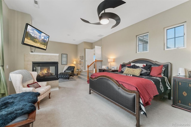 881 Kirby Ct, Watkins, CO 80137 - bedroom featuring carpet, a tile fireplace, and a ceiling fan