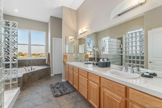 881 Kirby Ct, Watkins, CO 80137 - full bath with double vanity, a garden tub, stone finish floors, and tiled shower