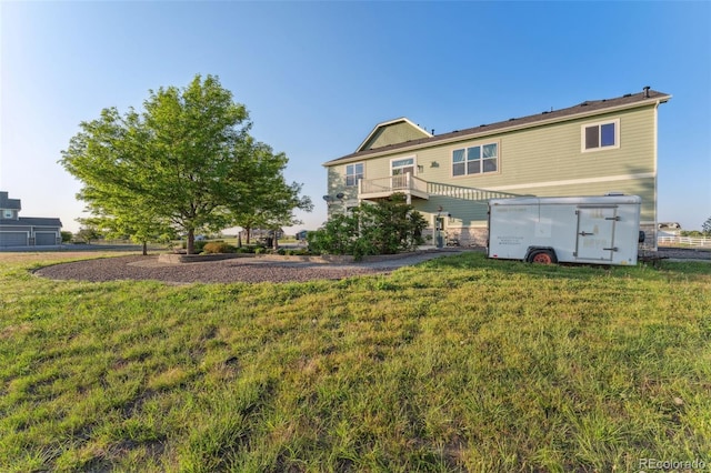 881 Kirby Ct, Watkins, CO 80137 - rear view of property with a lawn