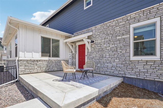 27593 E 1st Pl, Aurora, CO 80018 - property entrance featuring stone siding and board and batten siding