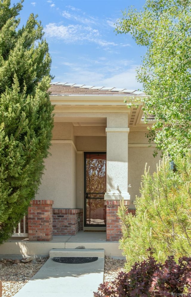 4519 Silver Mountain Loop, Broomfield, CO 80023 - entrance to property with stucco siding, covered porch, and brick siding