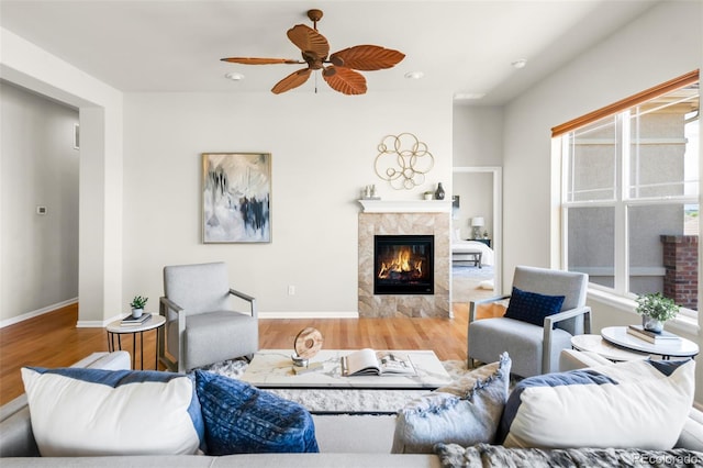 4519 Silver Mountain Loop, Broomfield, CO 80023 - living room featuring a fireplace, wood finished floors, ceiling fan, and baseboards