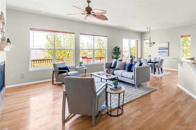 4519 Silver Mountain Loop, Broomfield, CO 80023 - living room with a ceiling fan, light wood-style flooring, baseboards, and a glass covered fireplace