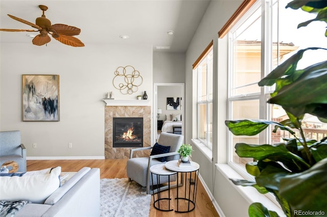 4519 Silver Mountain Loop, Broomfield, CO 80023 - living area with a premium fireplace, wood finished floors, ceiling fan, and baseboards