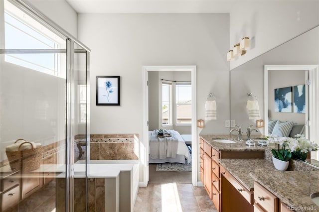 4519 Silver Mountain Loop, Broomfield, CO 80023 - ensuite bathroom featuring a shower stall, vanity, tile patterned flooring, and a tub to relax in