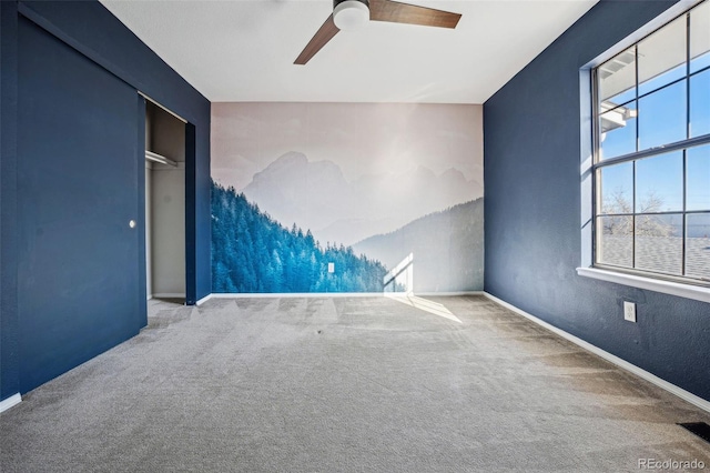 empty room with ceiling fan and carpet floors