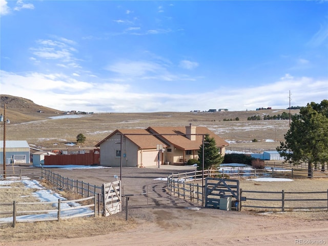 view of yard with a mountain view and a rural view