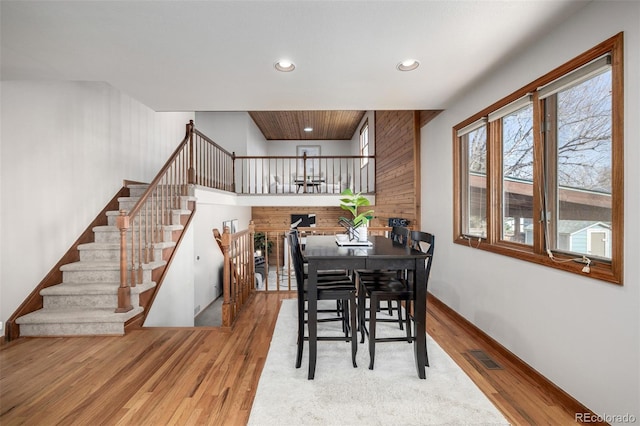 dining room with stairway, recessed lighting, wood finished floors, and baseboards