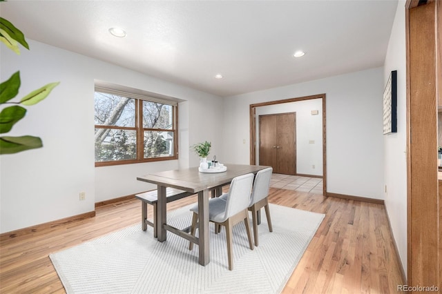 dining space with light wood-style flooring, recessed lighting, and baseboards