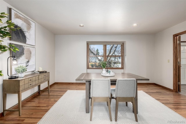 dining room featuring recessed lighting, baseboards, and wood finished floors