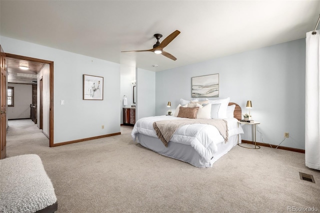 bedroom featuring visible vents, light carpet, baseboards, and a ceiling fan