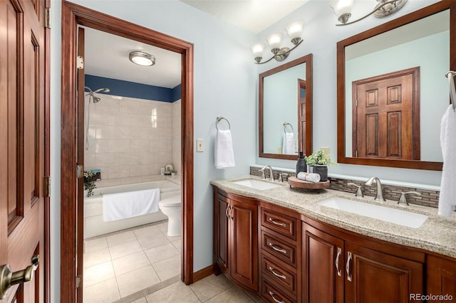 bathroom featuring a sink, toilet, double vanity, and tile patterned flooring