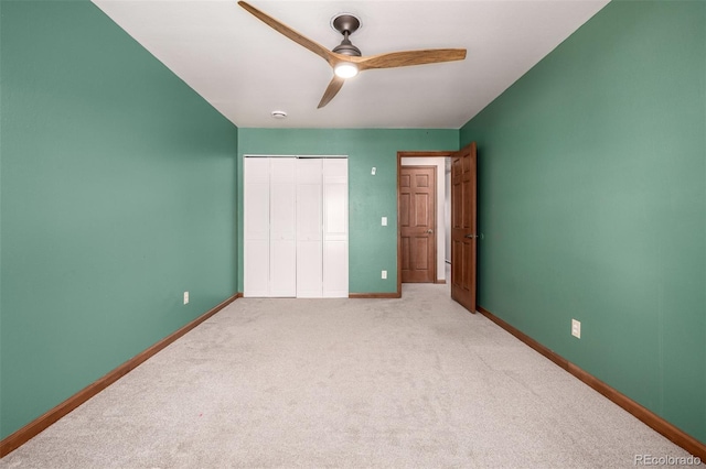 unfurnished bedroom featuring a closet, ceiling fan, baseboards, and carpet floors