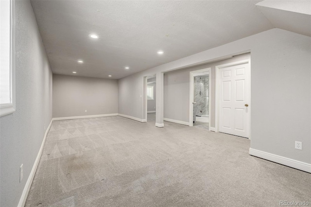 basement featuring recessed lighting, baseboards, and carpet