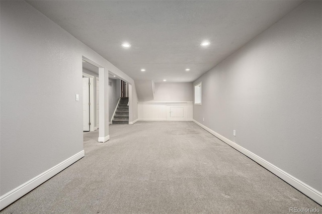 finished basement featuring stairway, carpet flooring, recessed lighting, and baseboards