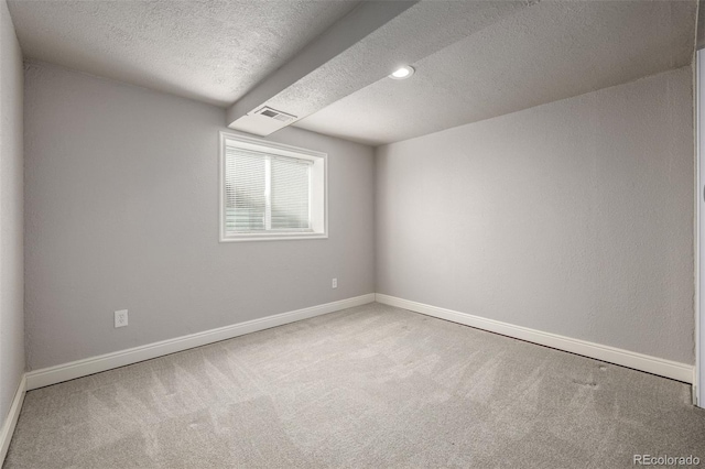 empty room featuring visible vents, baseboards, and carpet floors