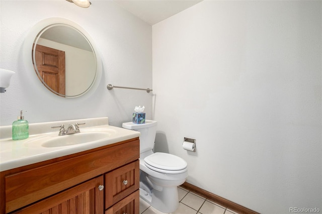 half bathroom with baseboards, toilet, vanity, and tile patterned flooring