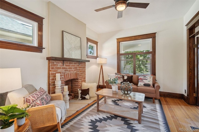 sitting room featuring a fireplace, ceiling fan, and hardwood / wood-style floors