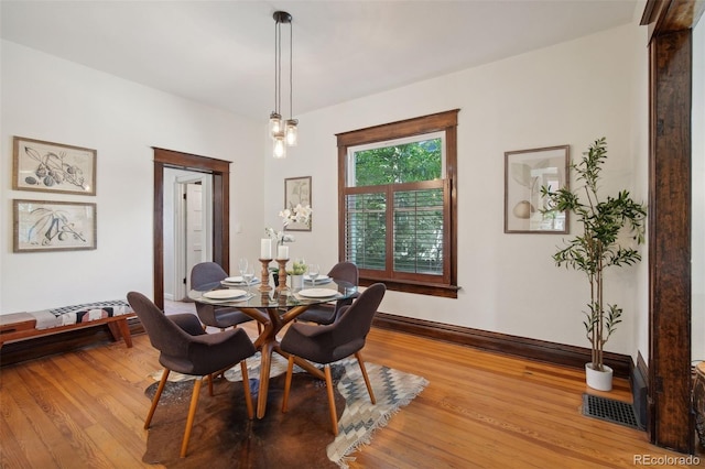 dining space with light hardwood / wood-style floors