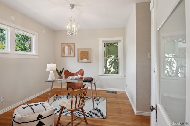 office space with a chandelier and wood-type flooring