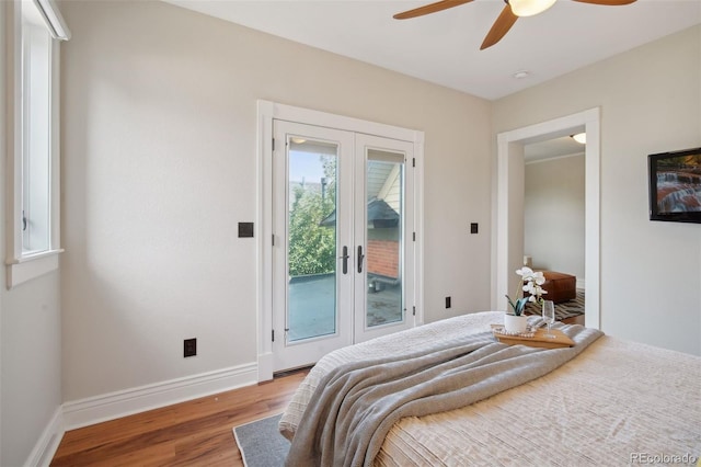 bedroom featuring access to exterior, hardwood / wood-style floors, french doors, and ceiling fan