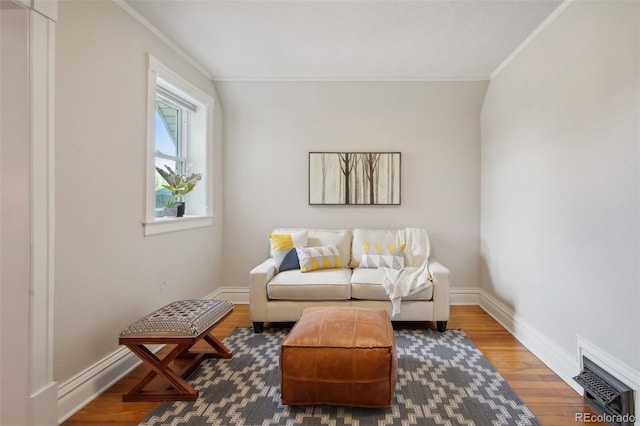 living area featuring wood-type flooring and ornamental molding