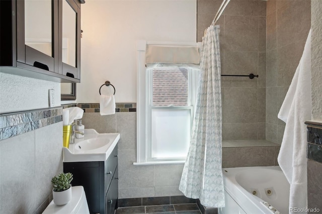 bathroom featuring shower / tub combo with curtain, vanity, tile walls, and tile patterned flooring