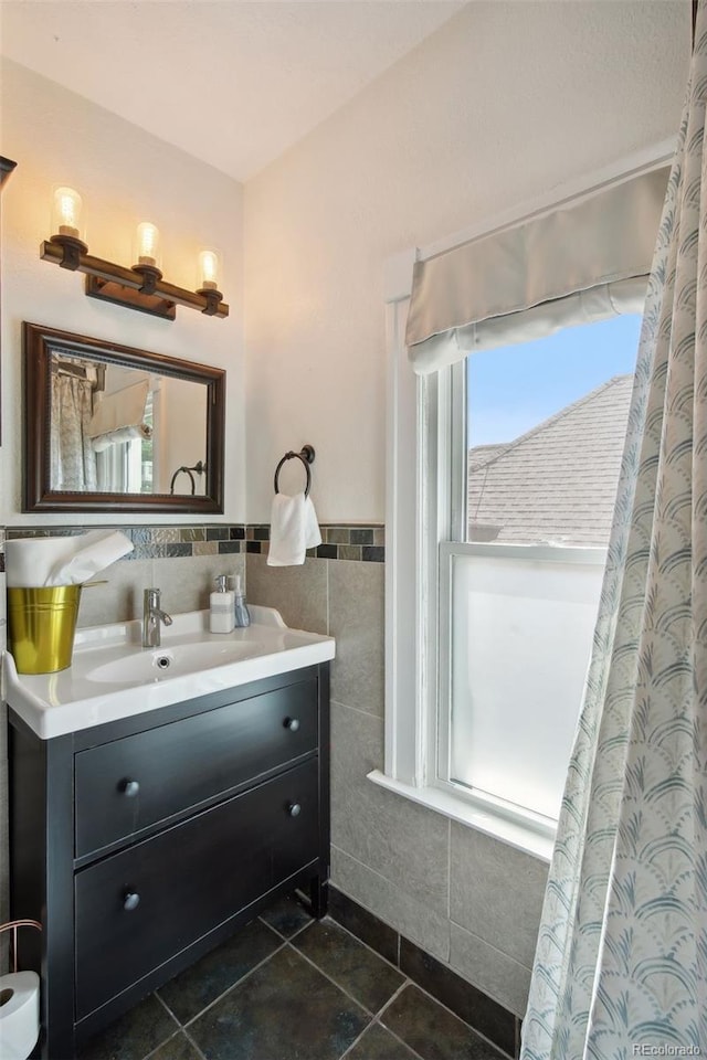 bathroom featuring tile patterned floors, vanity, and tile walls