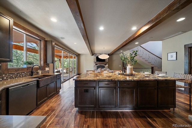8090 S Homesteader Dr, Morrison, CO 80465 - kitchen with stainless steel dishwasher, dark wood-type flooring, beam ceiling, light stone counters, and a center island