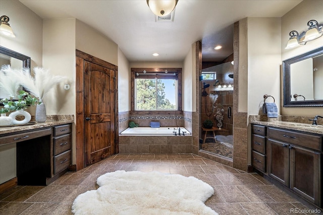 8090 S Homesteader Dr, Morrison, CO 80465 - bathroom featuring a garden tub, a tile shower, vanity, stone tile flooring, and recessed lighting