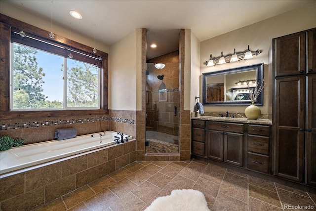 8090 S Homesteader Dr, Morrison, CO 80465 - full bathroom with vanity, a garden tub, a stall shower, and recessed lighting